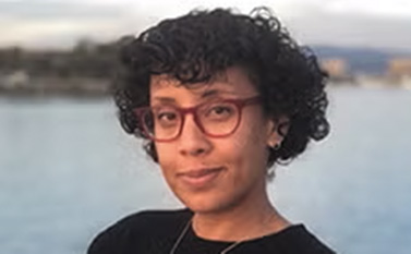 Fanna Gamal headshot on background with water and trees surrounding