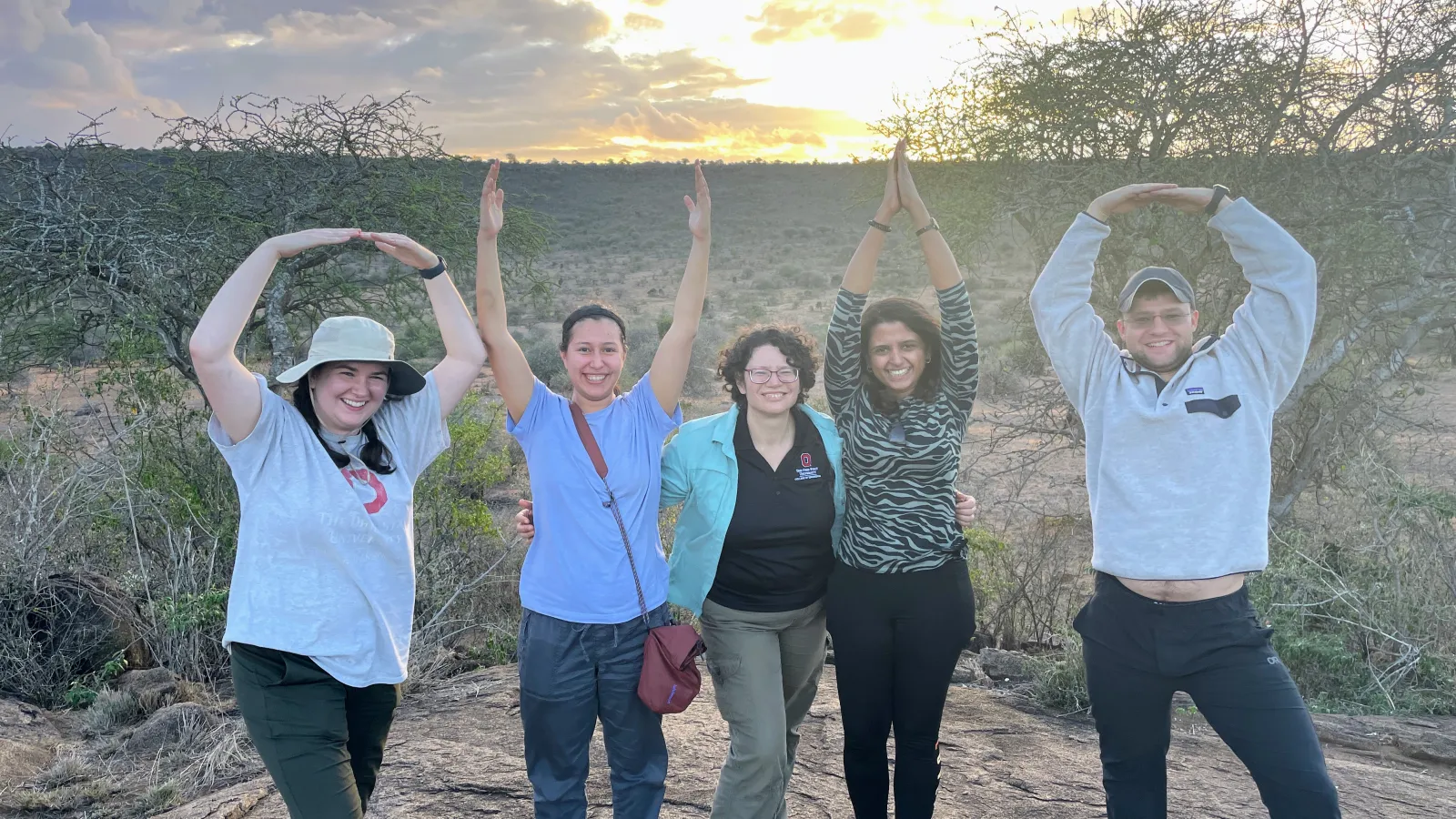 Dr. Tanya Berger-Wolf stands among students forming O-H-I-O with their arms