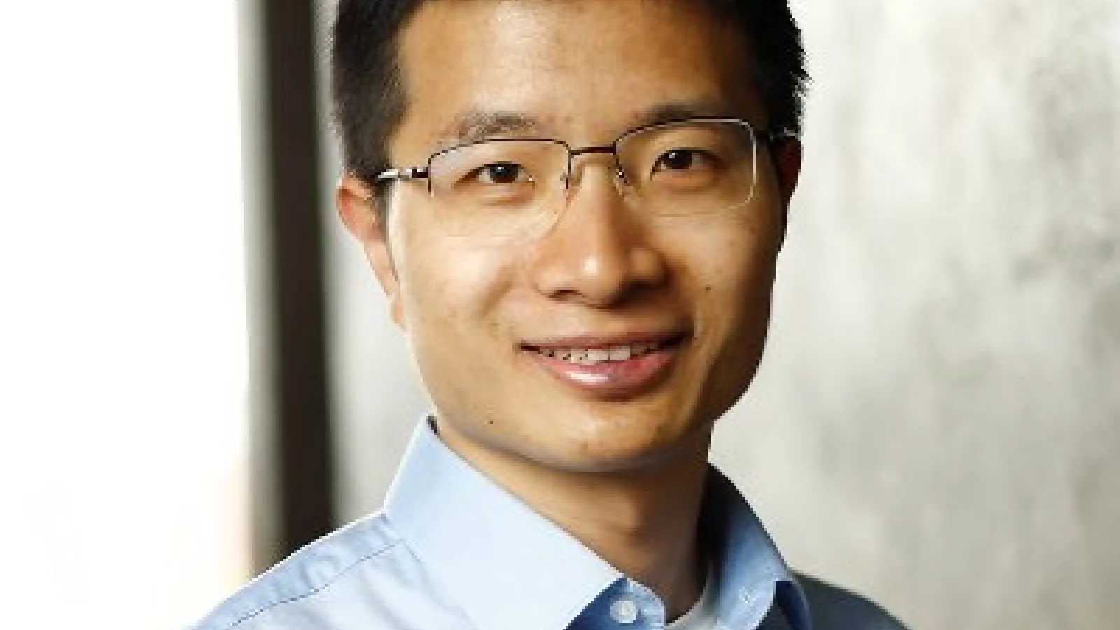 Weijie Su headshot on grey background