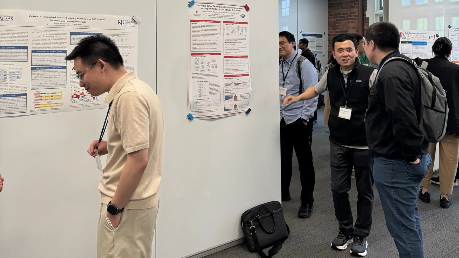 people in poster session with white boards 