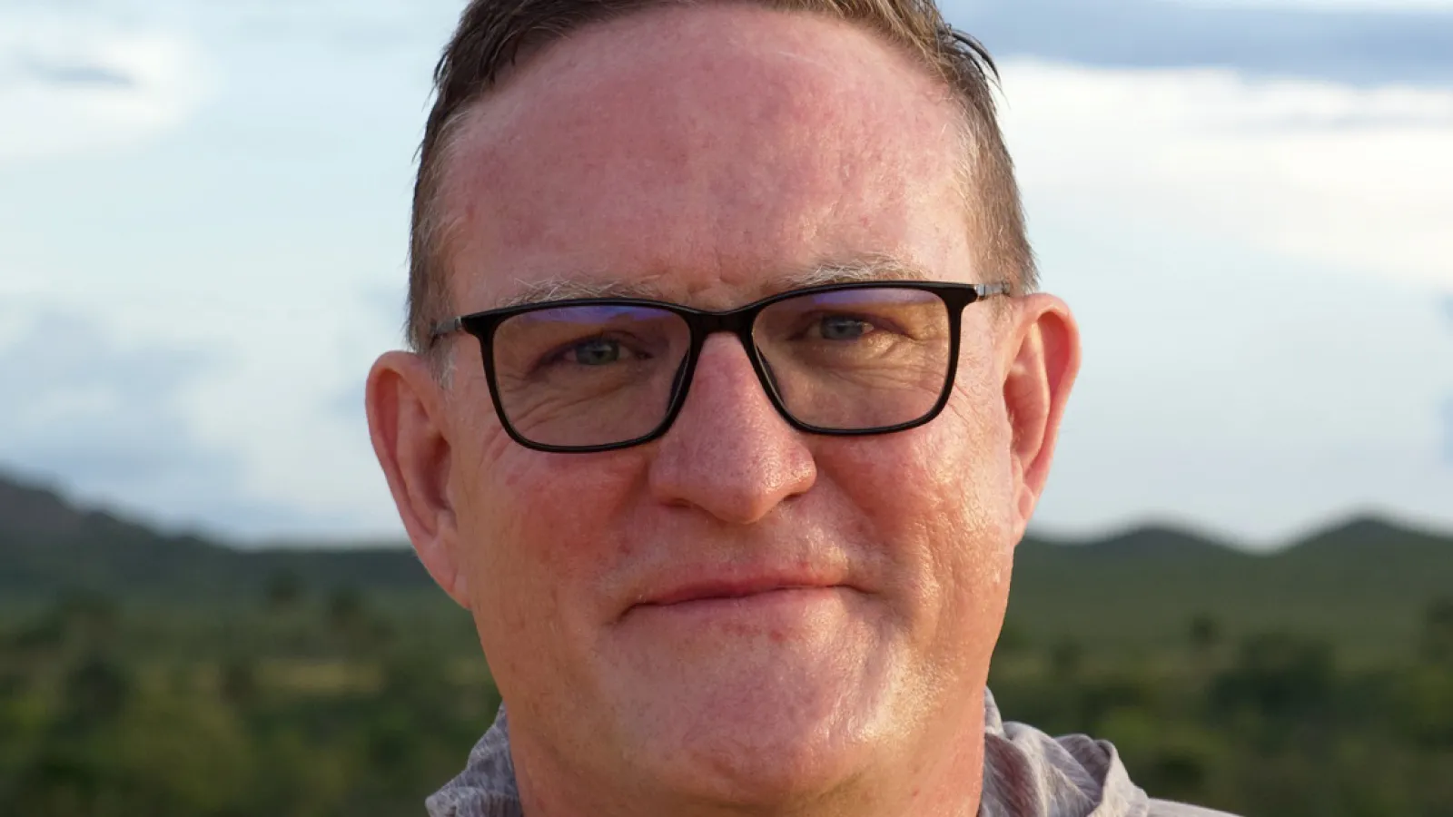 dr. sam clark in a grey sweatshirt in the outdoors