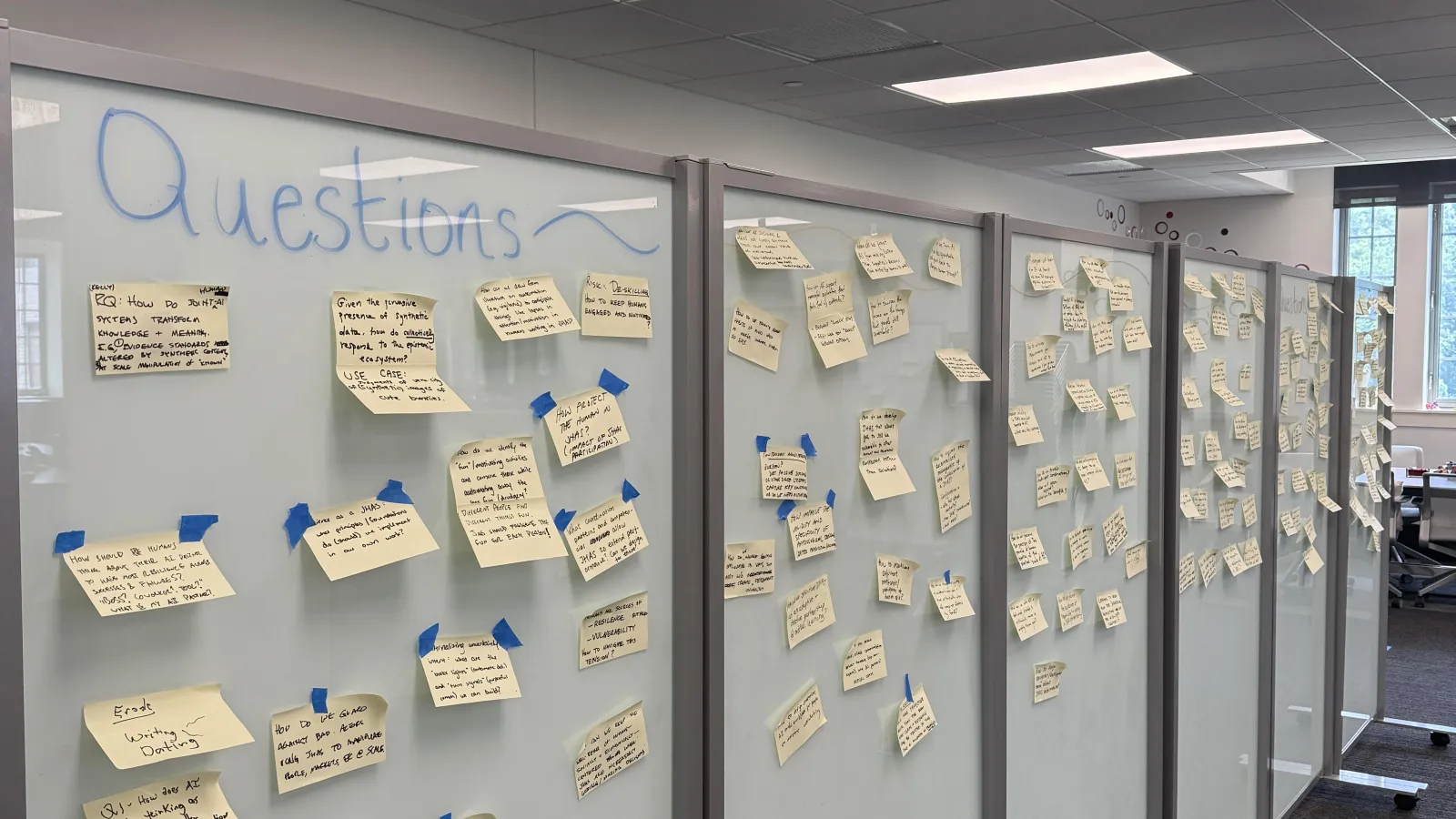 questions on post it notes on wall 