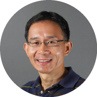 Headshot of Xiaolin Cheng wearing glasses and a collared shirt, smiling against a neutral background.