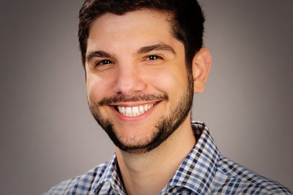 Luka Brkljacic, a white man with neatly trimmed facial hair and short dark hair smiles