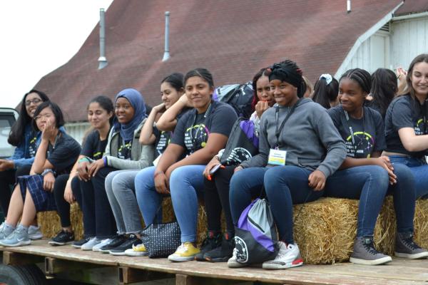2019 camp participants on the Waterman Farms visit, sitting on a hayride wagon