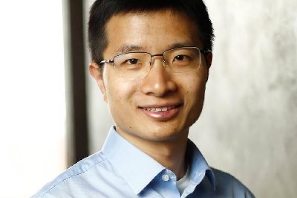 Weijie Su headshot on grey background