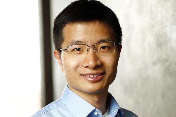 Professor Weijie Su on a gray wall background