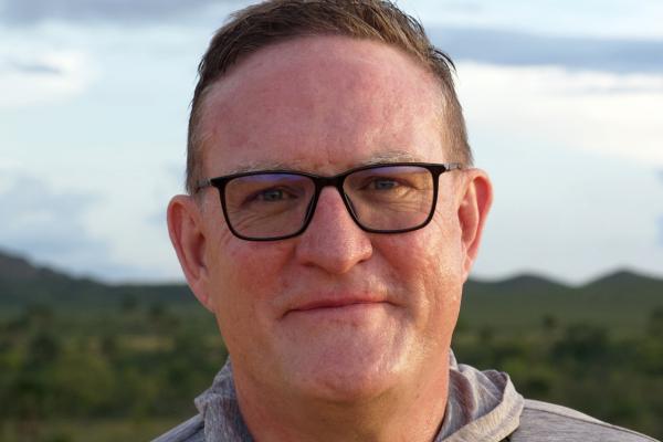 dr. sam clark in a grey sweatshirt in the outdoors