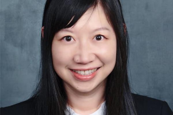 Dr. Weidan Cao headshot on a gray background
