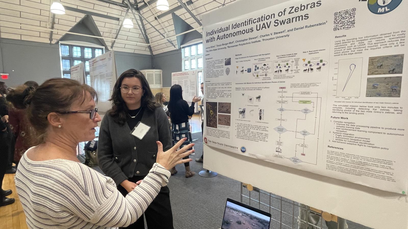 Jenna Kline talking with attendee about Identification of Zebras with Autonomous UAV swarms