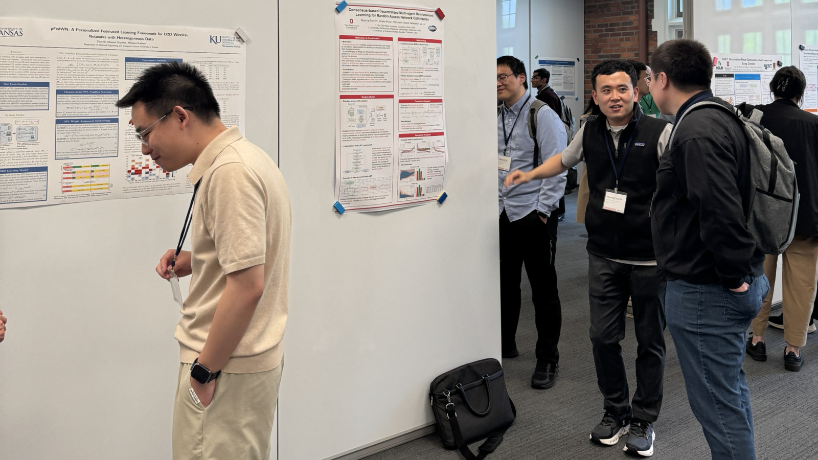 people in poster session with white boards 