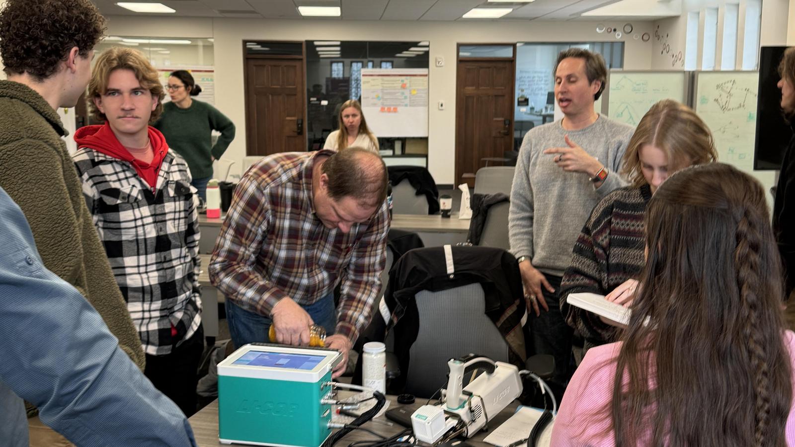 A workshop participant uses a LI-6800 portable photosynthesis system to measure leaf gas exchange during the TDAI-hosted LI-COR training in Pomerene Hall.