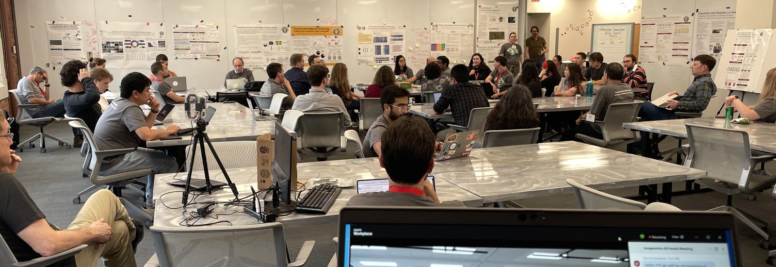 A room full of faculty and students discussing science and research posters hanging on the walls