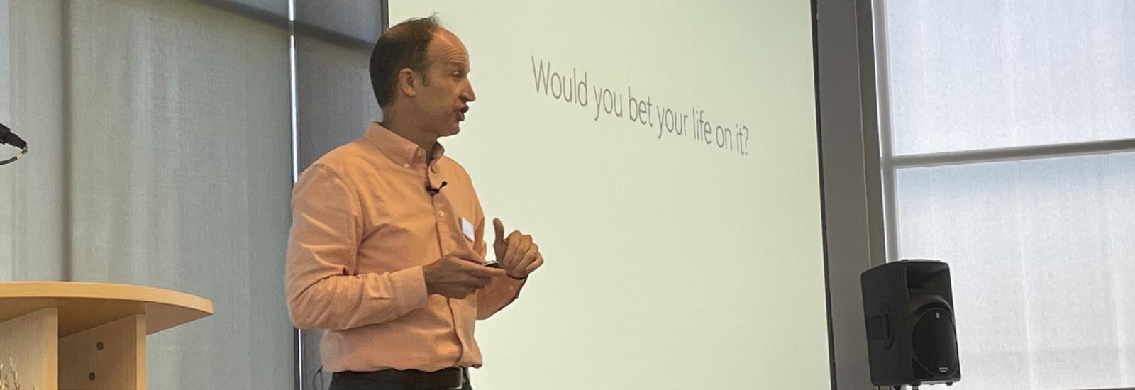 Dr Mike Rayo delivers a talk on responsible AI, with a slide that reads "Would you bet your life on it?"