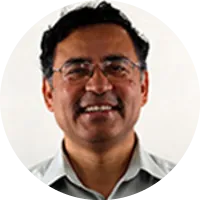 Headshot of Somesh Jha wearing glasses and a collared shirt, smiling against a neutral background.