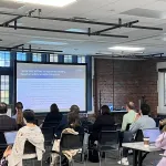 A person presenting in front of a group