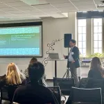 A person presenting in front of a group
