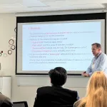 A person presenting in front of a group