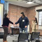 A person presenting in front of a group
