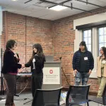 A person presenting in front of a group