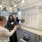 Jenna Kline talking with attendee about Identification of Zebras with Autonomous UAV swarms